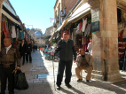 Fr. Keenan poses with his walking stick in front of the old market section in Jerusalem.